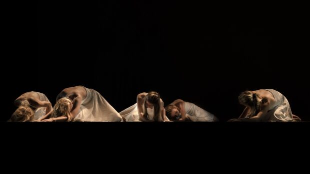 Four ballet dancers in flowing dresses perform on a dark stage in ballet wallpapers, 4K Desktop Wallpaper