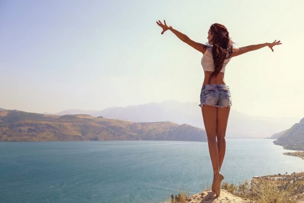 A dancer balances on pointe near a scenic lake with mountains in the background in ballet wallpapers, HD Desktop Wallpaper