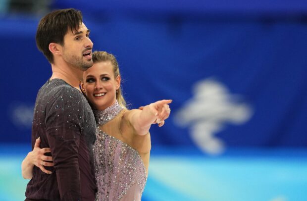 A figure skating duo performing a graceful ice dancing routine on the rink, 2K Desktop Wallpaper