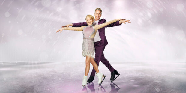 A graceful ice dancing couple is posing with synchronized arms extended on the ice rink, 2K Desktop Wallpaper