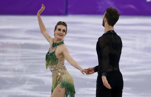A graceful ice dancing couple is performing a routine on the ice rink, HD Desktop Wallpaper
