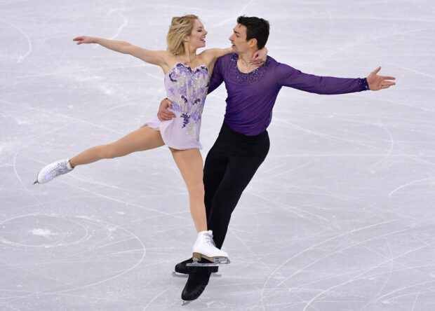 A skilled couple performs an elegant ice dancing routine on the rink, HD Desktop Wallpaper