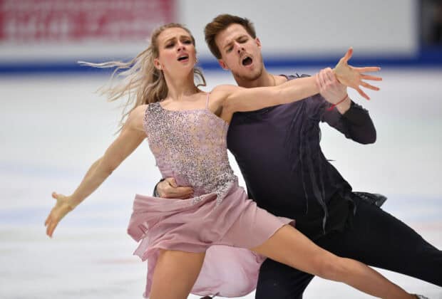 A talented couple performs a passionate ice dancing routine on the rink, HD Desktop Wallpaper