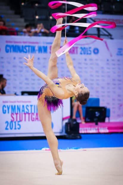 A gymnast performs an elegant ribbon routine in rhythmic gymnastics, HD Mobile Wallpaper