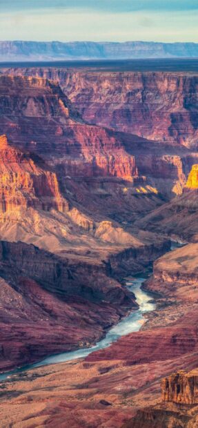 The Grand Canyon displays vivid layers of rock with a river flowing through, 2K Phone Wallpaper