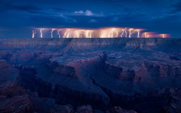 Lightning illuminates clouds over the Grand Canyon at night, 2K Desktop Wallpaper