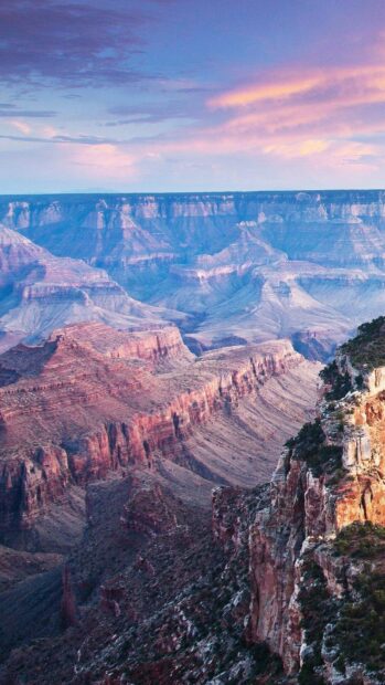 The Grand Canyon displays vibrant colors and vast rock formations under a pink sky, HD Phone Wallpaper