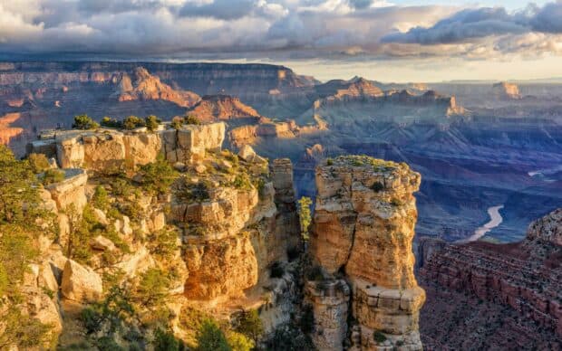 The Grand Canyon shows layered rock formations and a winding river under a colorful sky, 2K Desktop Wallpaper