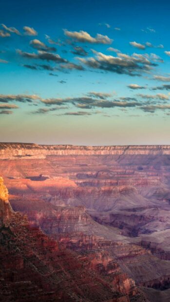 The Grand Canyon shows layered rock formations under a partly cloudy sky at sunset, HD Phone Wallpaper