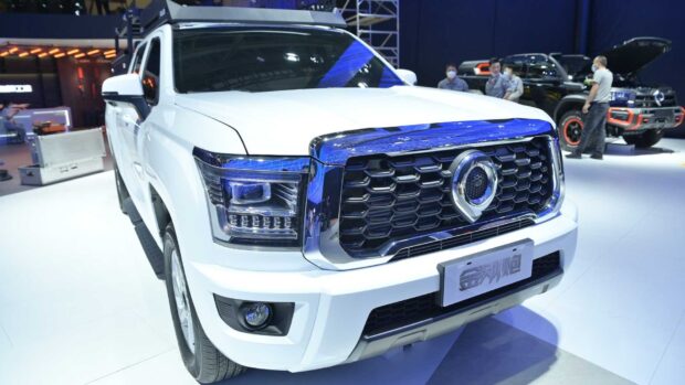 The white Great Wall Motors vehicle is showcased at the auto event with people in the background, HD Desktop Wallpaper