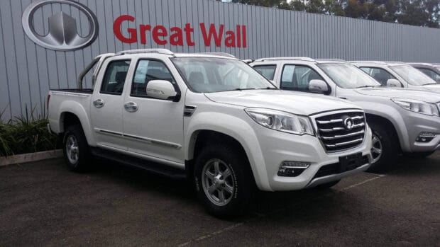 A white Great Wall Motors pickup truck parked in front of a dealership sign, HD Desktop Wallpaper