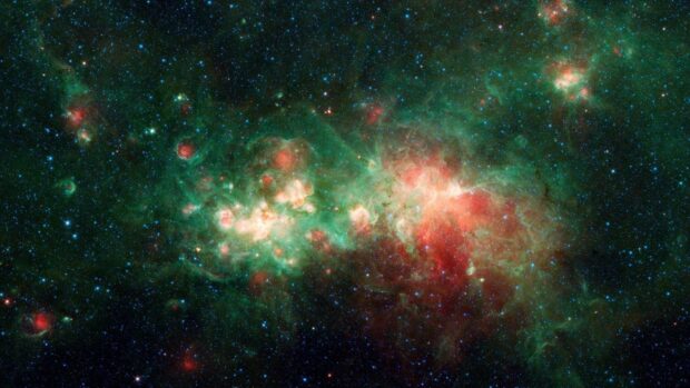 The image shows a glowing green nebula with red highlights in deep space, HD Desktop Wallpaper