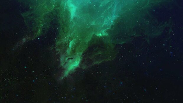 A green nebula glows brightly among distant stars in deep space, HD Desktop Wallpaper