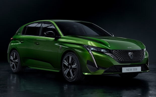 A green Peugeot 308 is parked inside with glossy reflections on the body, HD Desktop Wallpaper