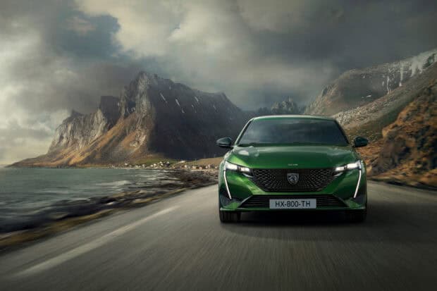 A green Peugeot 308 is driving along a coastal road with mountains in the background, HD Desktop Wallpaper