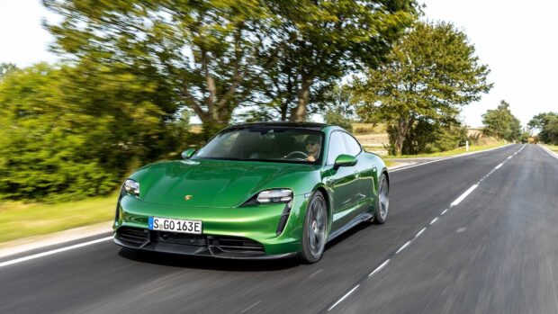 A green Porsche Taycan is driving fast along a tree lined rural road, HD Desktop Wallpaper