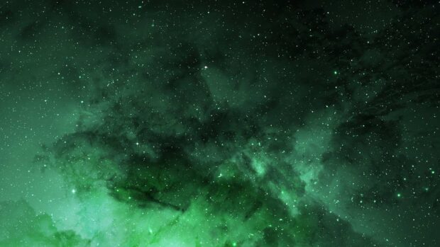 A stunning green nebula filled with stars is glowing brightly in deep space, HD Desktop Wallpaper