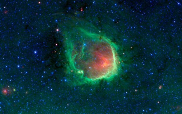 A glowing green nebula with red core surrounded by stars in deep space, HD Desktop Wallpaper