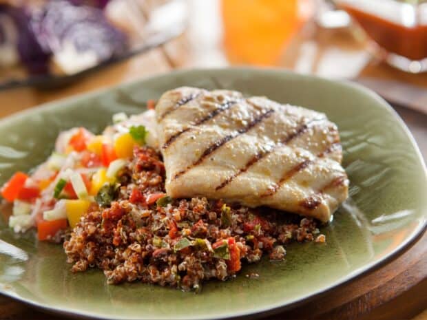 A plate of grilled chicken served with a quinoa mix and fresh vegetable salad, HD Desktop Wallpaper