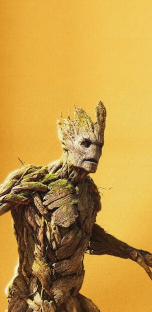 The image shows Groot from Marvels Guardians Of The Galaxy with detailed textures on a yellow background, 2K Phone Wallpaper