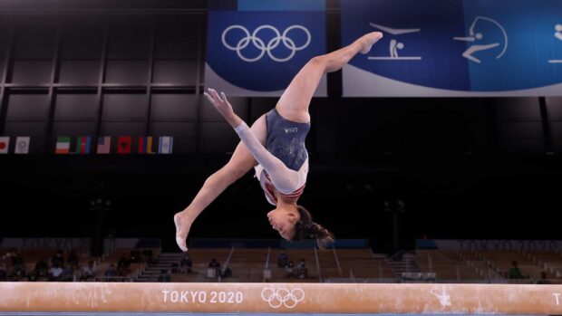 A gymnast executes a flip on the balance beam at the Tokyo 2020 Olympics, HD Desktop Wallpaper