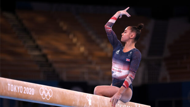A gymnast is performing a routine on the balance beam at the Tokyo 2020 Olympics, HD Desktop Wallpaper