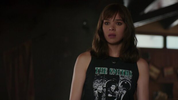 Hailee Steinfeld looks surprised wearing a sleeveless top in a dimly lit room with visible background details, HD Desktop Wallpaper