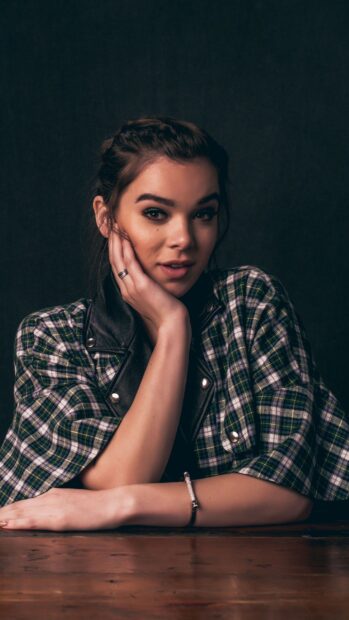A portrait of Hailee Steinfeld wearing a plaid shirt and resting her face on her hand, 2K Mobile Wallpaper