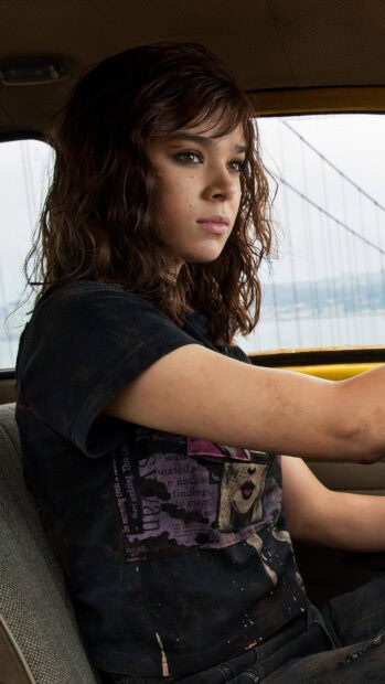 Hailee Steinfeld is sitting inside a car looking focused with a bridge in the background, 4K Mobile Wallpaper
