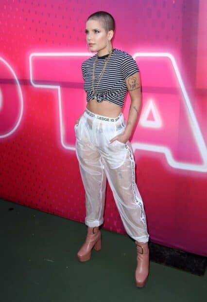 Halsey wallpapers showing a woman in a striped top and transparent pants standing confidently, HD Mobile Wallpaper