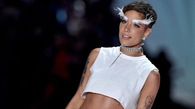 Halsey wears a white crop top with artistic makeup and accessories on stage, HD Desktop Wallpaper