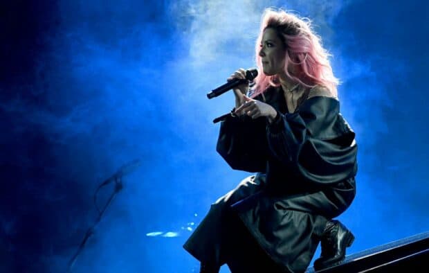 The singer Halsey is captured in a dynamic moment during her concert, HD Desktop Wallpaper