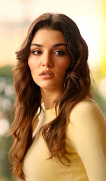 A close up of Hande Ercel showing her natural beauty and flowing hair in warm light, HD Phone Wallpaper