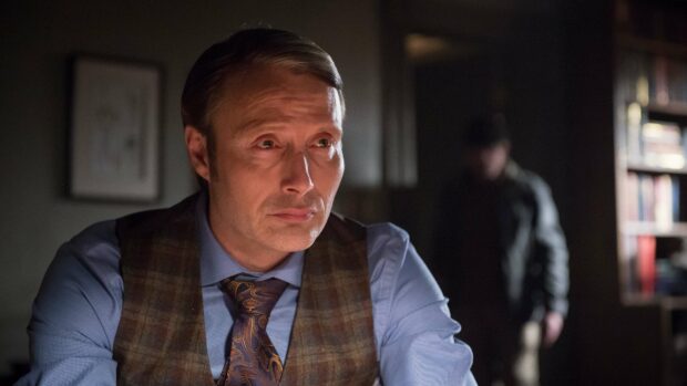 Hannibal Mads Mikkelsen looks thoughtfully in a dimly lit room, 4K Desktop Wallpaper
