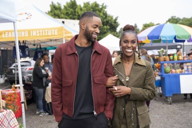 A happy couple from Insecure tv series walks arm in arm at an outdoor market, HD Mobile Wallpaper