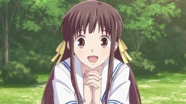 A happy girl from Fruits Basket anime is smiling with hands clasped in a green park, HD Desktop Wallpaper