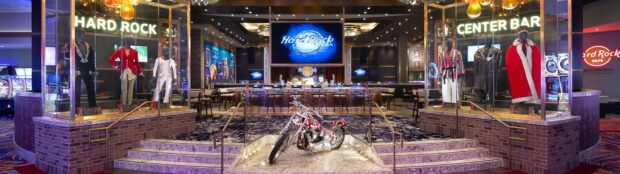 This image features a hard rock display with mannequins and a motorcycle in an indoor lounge, 4K Desktop Wallpaper