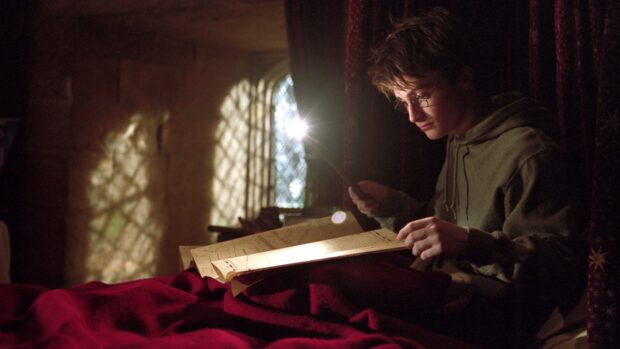 The Prisoner Of Azkaban Wallpapers, Harry Potter is carefully examining a magical map using a wand in a dimly lit room, 4K Desktop Wallpaper