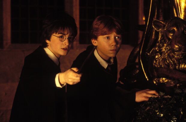 Harry and Ron cautiously investigate a mysterious chamber with a magical wand, 2K Desktop Wallpaper