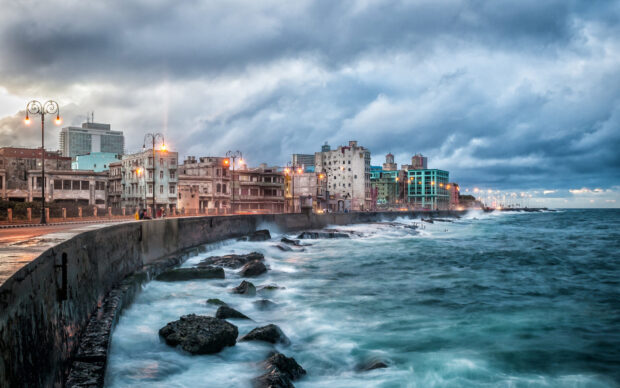 The Havana Cuba Wallpapers show a cloudy sky over old buildings by the rough sea, HD Desktop Wallpaper