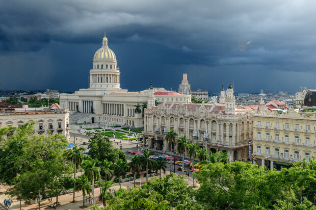The image shows Havana Cuba cityscape with the Capitol building under a stormy sky, HD Desktop Wallpaper