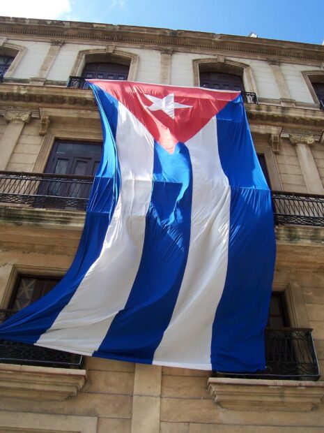 The Havana Cuba flag hanging from a historic building balcony in Havana Cuba, 2K Mobile Wallpaper