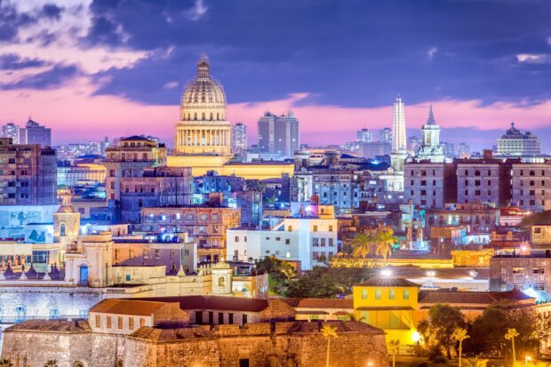 The Havana city skyline shows historic buildings and vibrant colors during sunset, 2K Desktop Wallpaper