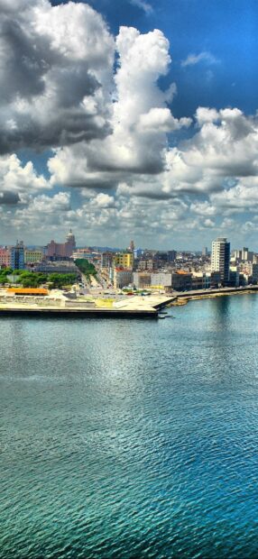 The Havana Cuba Wallpapers show a vibrant coastal city with detailed buildings and dramatic clouds, HD Phone Wallpaper