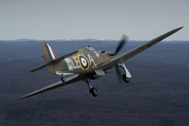 A Hawker Hurricane flying above a forest landscape on a clear day, HD Desktop Wallpaper