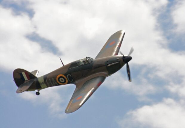 A Hawker Hurricane aircraft flies against a cloudy blue sky, 2K Desktop Wallpaper