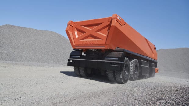 A heavy duty Scania truck transports materials in a gravel quarry under clear blue sky, 2K Desktop Wallpaper