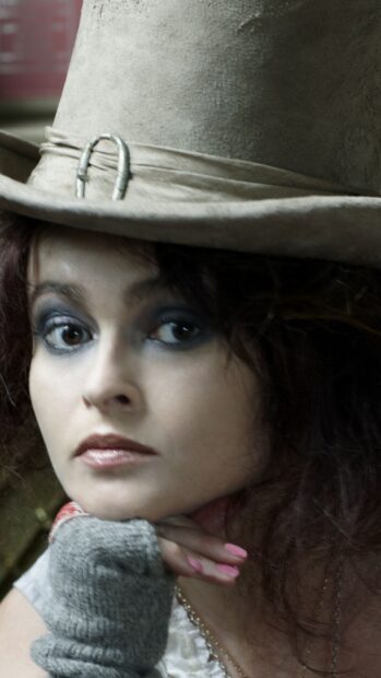 Helena Bonham Carter wears a large hat and makeup with a thoughtful expression, HD Mobile Wallpaper
