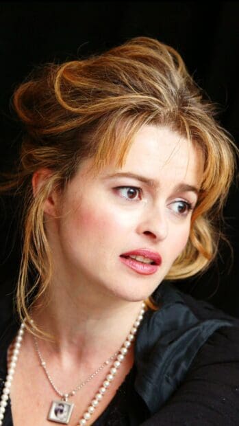 Helena Bonham Carter looks thoughtfully to the side wearing a pearl necklace, HD Mobile Wallpaper