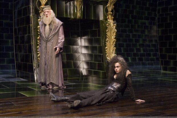 Helena Bonham Carter in a dark costume sitting on the floor with a wizard in the background, HD Desktop Wallpaper